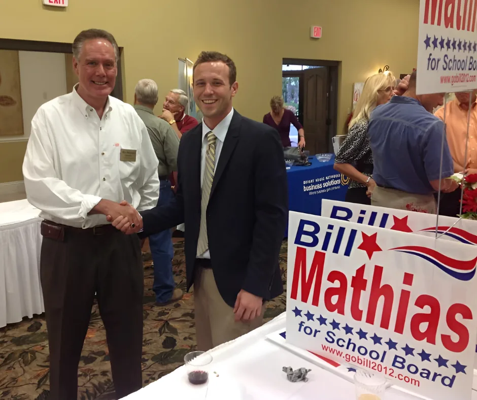 Mikel shaking hands with Bill Mathias at a campaign event